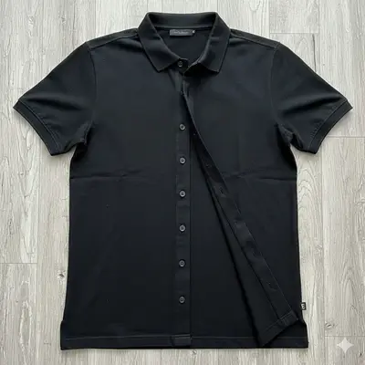 Black short-sleeve shirt on a wooden surface